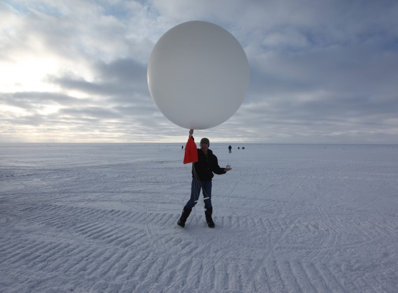En tekniker släpper en väderballong vid USA:s forskningsstation vid Summit, på den grönländska inlandsisen 3 200 meter över havet.