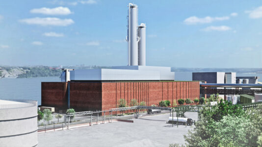 Visionsbild för framtida bio-CCS-anläggning i rött tegel med grå skorstenar.