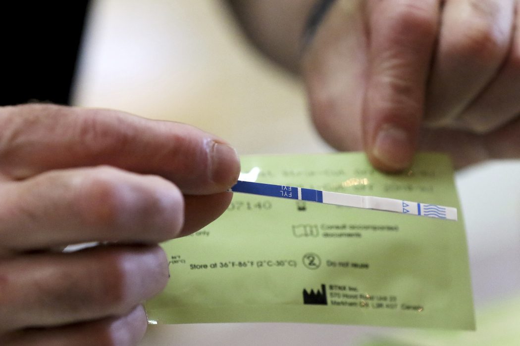 Warp Corps co-owner Rob Mutert shows a fentanyl testing strip available at his location on Friday, June 21, 2019 in Woodstock, Ill. The new sober business on the historic Woodstock Square hosts support meetings and integrates an art gallery, clothing, skateboarding equipment, the Max Happy brand of coffee, music, and much more. (Matthew Apgar/Northwest Herald via AP)