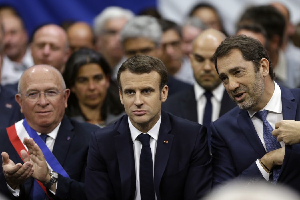 French President Emmanuel Macron, center, flanked with Greoux Les Bains' mayor Paul Audan, left, and French Interior Minister Christophe Castaner, right, attend a meeting as part of the "great national debate" on ecology matters in Greoux Les Bains, south of France, Thursday, March 7, 2019. (AP Photo/Claude Paris, Pool)
