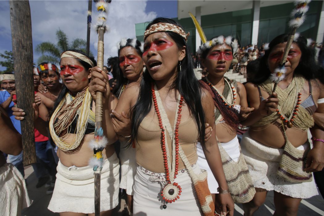 Waoranis and leader Nemonte Nenquimo celebrate after a judged ruled in their favor in a lawsuit filed against the Ministry of Non-Renewable Natural Resources for opening up oil concessions on their ancestral land, in Puyo, Ecuador, Friday, April 26, 2019. (AP Photo/Dolores Ochoa)