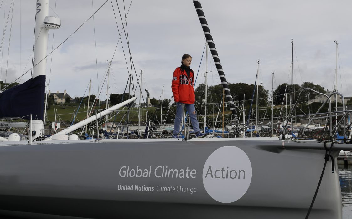 Greta Thunberg walks on the boat Malizia as it is moored in Plymouth, England Tuesday, Aug. 13, 2019. Greta Thunberg, the 16-year-old climate change activist who has inspired student protests around the world, is heading to the United States this week - in a sailboat. (AP Photo/Kirsty Wigglesworth)
