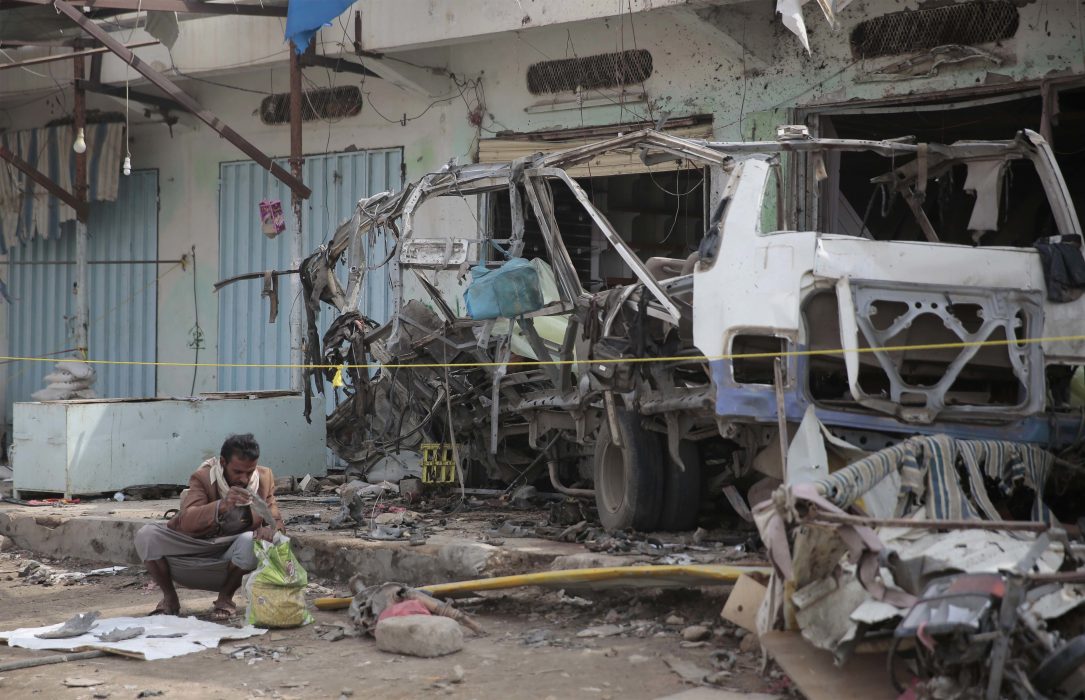 A man inspects the wreckage of a bus at the site of a deadly Saudi-led coalition airstrike on Thursday, in Saada, Yemen, Sunday, Aug. 12, 2018. Yemen's shiite rebels are backing a United Nations' call for an investigation into the airstrike in the country's north that killed dozens of people including many children. (AP Photo/Hani Mohammed)