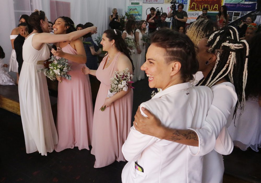 Gay couples greets each other after they get married in a group marriage of forty same sex couples in Sao Paulo, Brazil, Saturday, Dec. 15, 2018. With the election of ultra-rightist Jair Bolsonaro as president, hundreds of same sex couples began to marry, fearing that the administration of Bolsonaro, who accumulates a history of homophobic and derogatory comments towards gays, could hinder the union of people of the same sex. (AP Photo/Nelson Antoine)